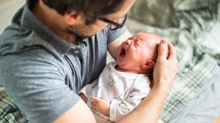 Father holding crying baby
