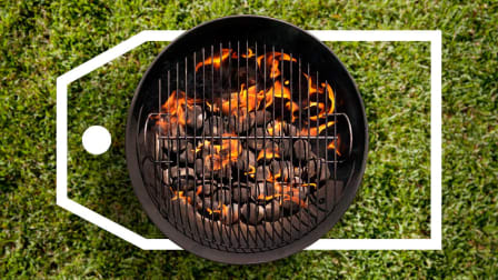 Top-down view of a charcoal grill sitting on grass with a large deals tag surrounding it.
