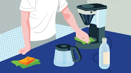 Person cleaning a coffee maker