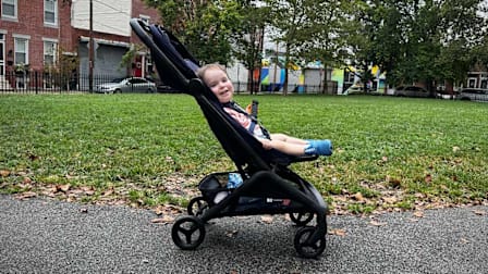 Baby smiling in a Bugaboo Butterfly stroller.