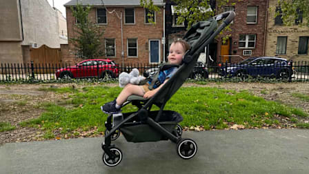 A toddler sitting in the  The Joolz Aer+ Stroller in a park.