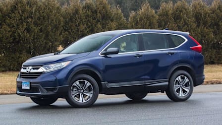 blue 2017 Honda CR-V on asphalt with trees and grass in background