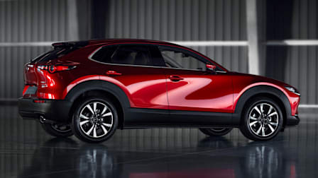 red Mazda CX-30 inside concrete and metal building