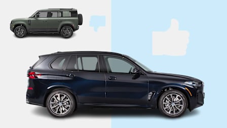 2026 Land Rover Defender next to graphic thumbs down icon and 2026 BMW X5 next to graphic thumbs up icon