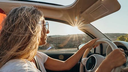 Woman smiling driving on a sunny day
