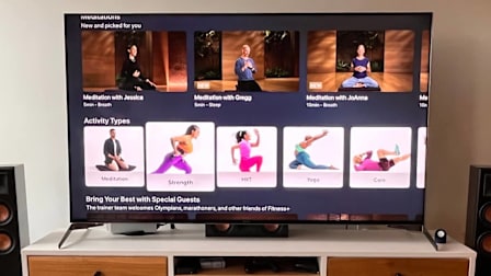 close up of TV in on TV stand with Apple Fitness+ on TV screen