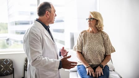 Doctor consulting with patient in exam room.
