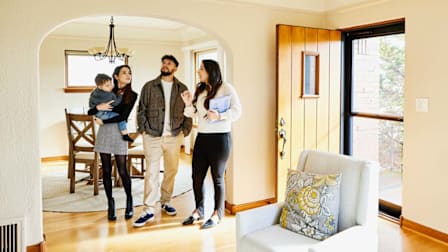 a family viewing a house for sale with a realtor.