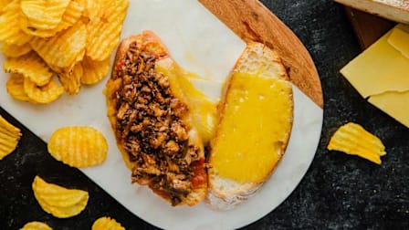 Oxtail Grilled Cheese and chips on a plate