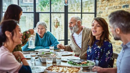 Table gathering of people having multiple conversations