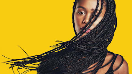 Black woman with braided hair extensions on yellow background