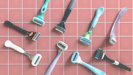 Nine razors on pink tile