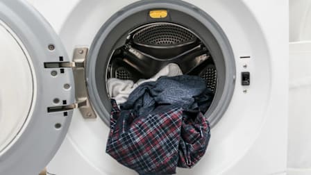 Laundry spilling out of a washing machine