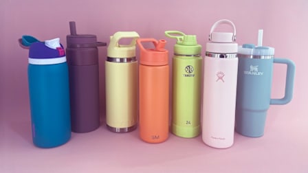 Seven watter bottles on pink background