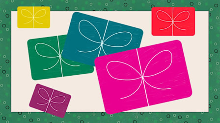 Several colorful gift cards arranged in a scattered layout.
