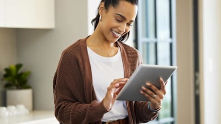 A woman at home using a tablet.