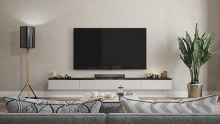 A living room with a TV mounted to the wall.
