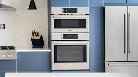 Bosch 800 Series HBL8753UC wall oven microwave combo in kitchen with blue cabinets