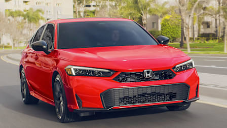 2025-2026 Honda Civic Hybrid Sport sedan driving on a city street
