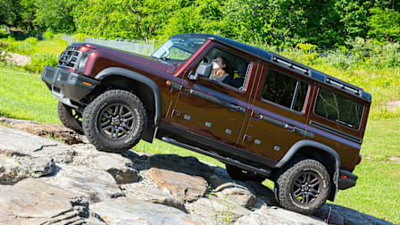 2026 Ineos Grenadier climbing the rock hill at Consumer Reports' Auto Test Center, view from side