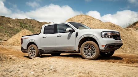 A 2023 Ford Maverick seen on a worksite with piles of dirt.