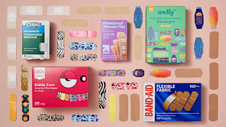 grid of Curad, Ouch Essentials, Up&Up, Band-Aid, and Welly bandage boxes and bandages