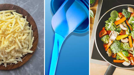 A bowl of shredded cheese on the left, a blue plastic scoop pouring liquid in the center, and a pan of colorful mixed vegetables (broccoli, carrots, mushrooms, and tomatoes) cooking on the right.
