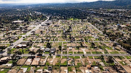 An aerial view shows empty lots and new homes under construction in Altadena, California on January 5, 2026.