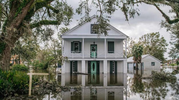 Floodwater surrounds a home on August 31, 2021 in Barataria, Louisiana.