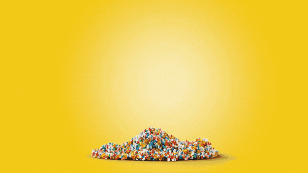 Dollar sign made of pills on yellow background