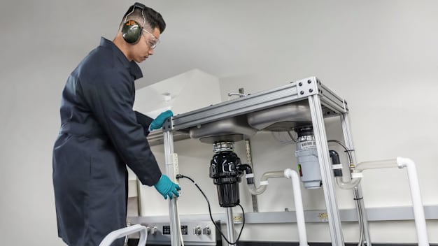 An engineer testing garbage disposals in lab