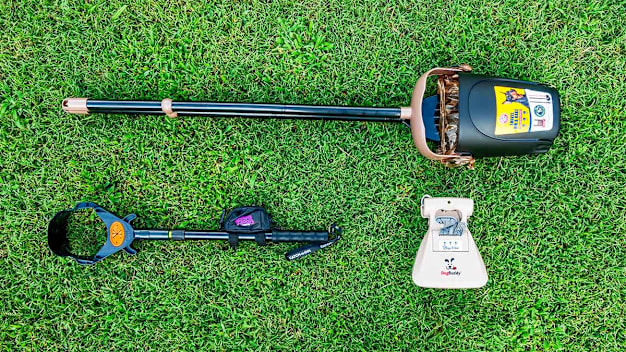 Arm & Hammer, Dog Buddy, and Pooch Approved poop scoopers on grass
