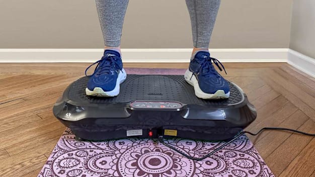 Consumer Reports editor testing the Lifepro Waver Vibration Plate Exercise Machine in her home.