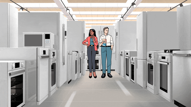 Two people are walking through an appliance showroom aisle lined with ovens, ranges, refrigerators, dishwashers, and microwaves.