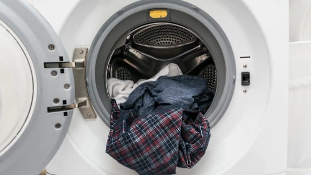 Laundry spilling out of a washing machine