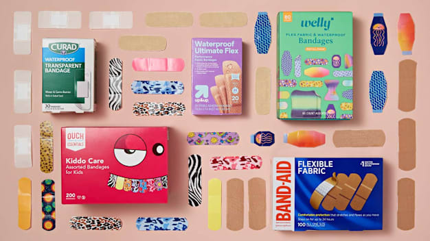 grid of Curad, Ouch Essentials, Up&Up, Band-Aid, and Welly bandage boxes and bandages