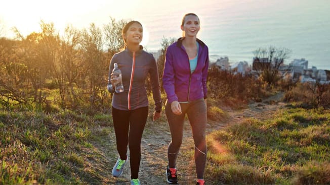 two women walking and exercising