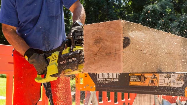 A close up of a CR tester using an electric chainsaw on a block of wood.