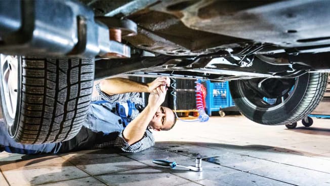 Mechanic working under a car