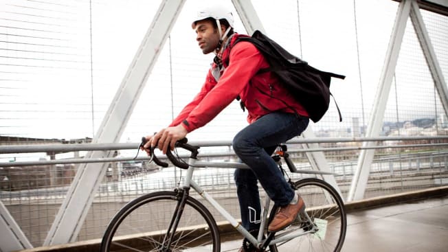 person riding bike on bridge