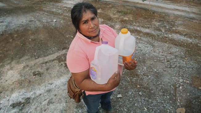 Florencia holding her water containers