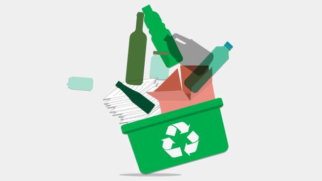 Recycling bin filled with paper, recyclable glass and plastic containers