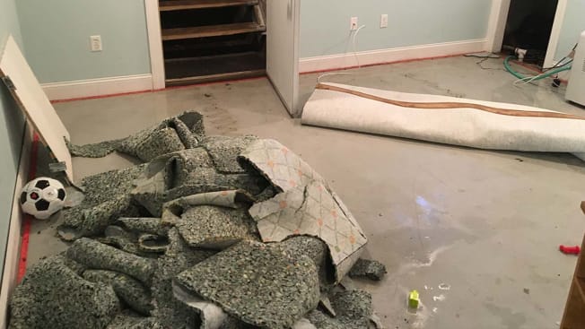 Flooded basement and torn up carpet