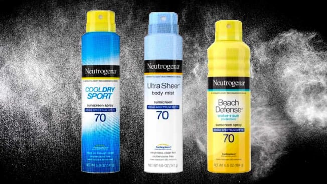 Three cans of Neutrogena spray sunscreen on a background that shows white aerosol spray.