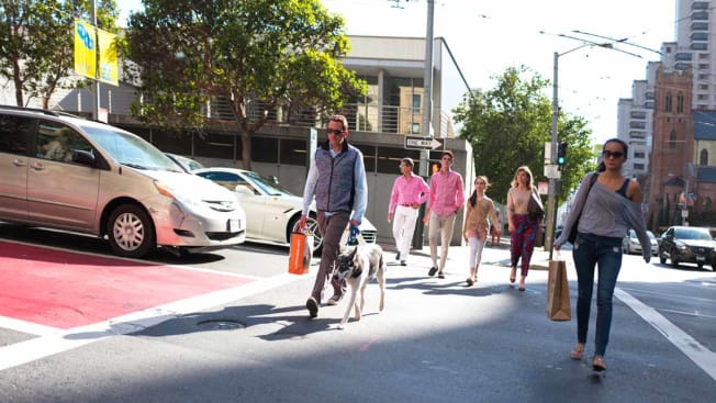 A group of people cross a street at a crosswalk, San Francisco, California