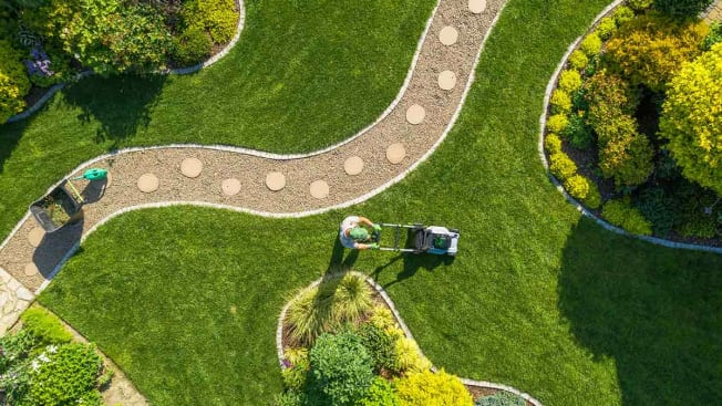 Aerial view of person mowing their lawn.