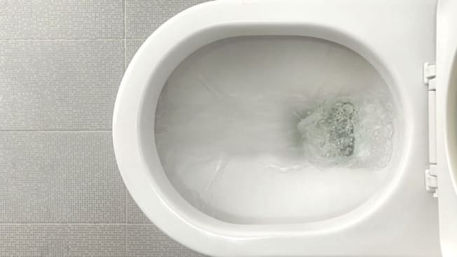 Water flushes down toilet bowl