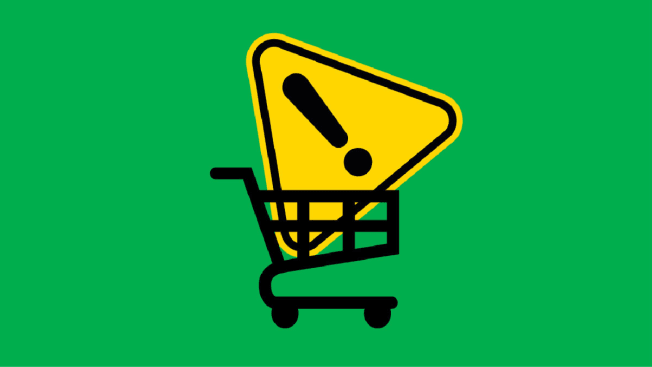 Yellow caution icon in shopping cart on green background