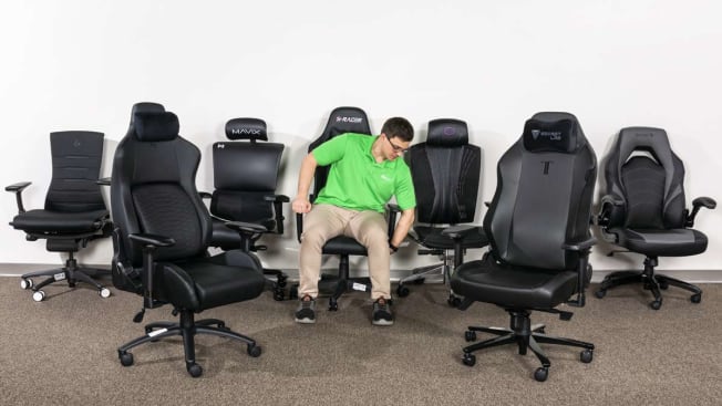 person wearing Consumer Reports shirt in gaming chair with other gaming chairs around them