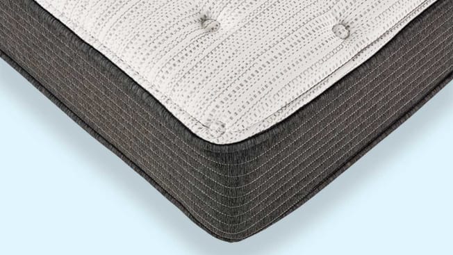 Corner of Beautyrest Silver BRS900-TSS illustrated atop blue background.